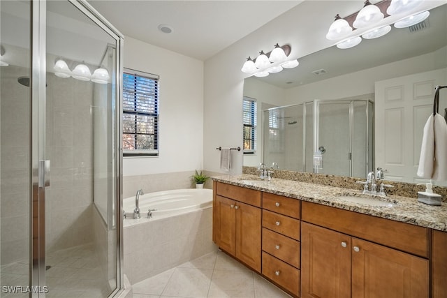 full bath with double vanity, a stall shower, a sink, tile patterned flooring, and a bath