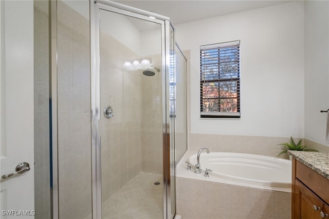 bathroom featuring a stall shower, vanity, and a bath