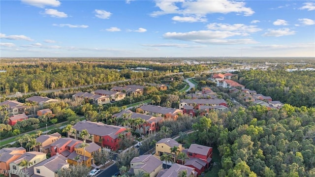 aerial view featuring a wooded view and a residential view