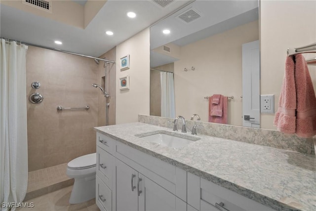 bathroom with toilet, a tile shower, and visible vents