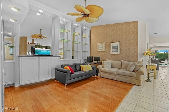 living room with ceiling fan, built in shelves, light wood finished floors, and recessed lighting