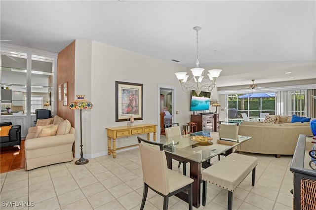 dining room featuring light tile patterned floors, baseboards, and ceiling fan with notable chandelier