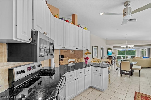 kitchen featuring light tile patterned floors, tasteful backsplash, visible vents, appliances with stainless steel finishes, and white cabinetry