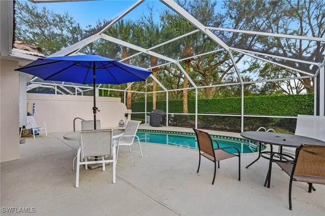 view of pool with a fenced in pool, a patio, area for grilling, outdoor dining space, and glass enclosure