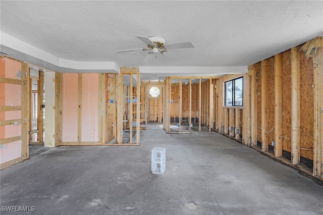 misc room with ceiling fan and a textured ceiling