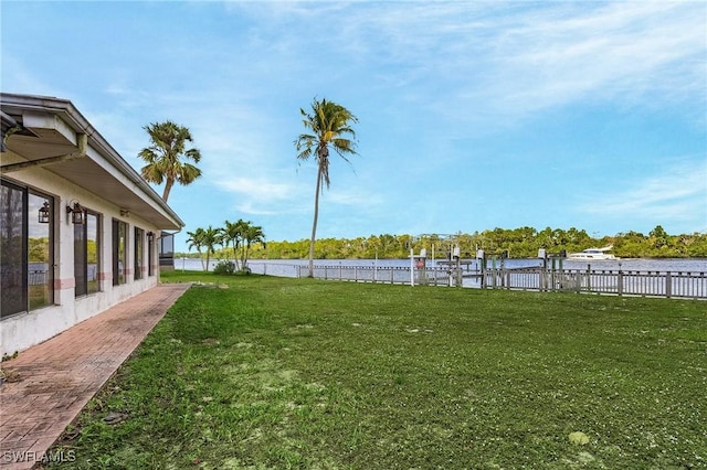 view of yard with a water view and fence