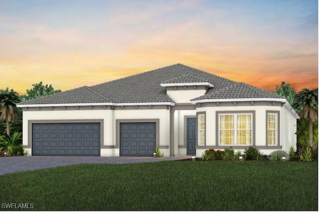 view of front facade with a garage, driveway, a front lawn, and a tile roof