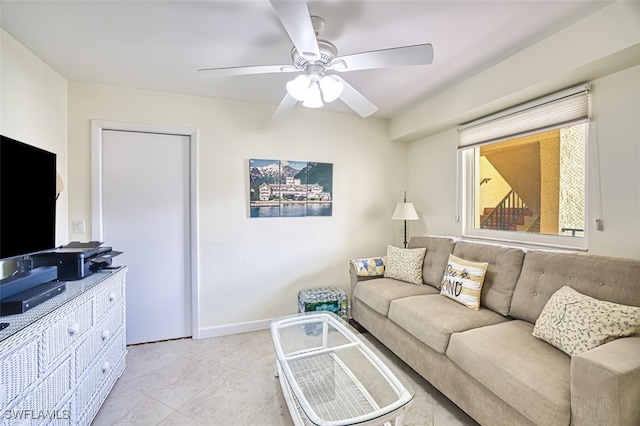 living room featuring ceiling fan and baseboards