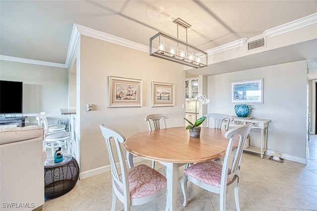 dining room with ornamental molding, visible vents, and baseboards