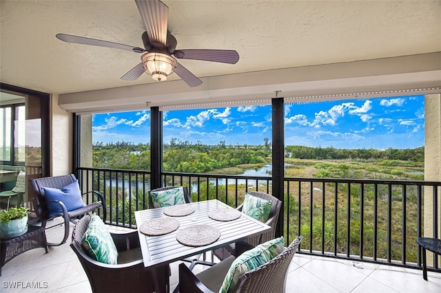 exterior space featuring a water view and ceiling fan