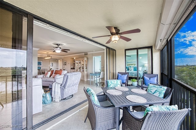 sunroom / solarium with a ceiling fan