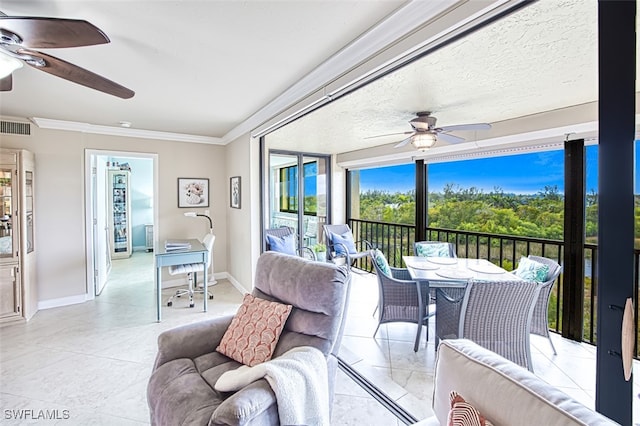 sunroom / solarium with a ceiling fan and visible vents