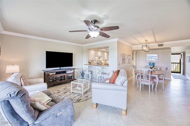 living area with baseboards, visible vents, ceiling fan, and crown molding