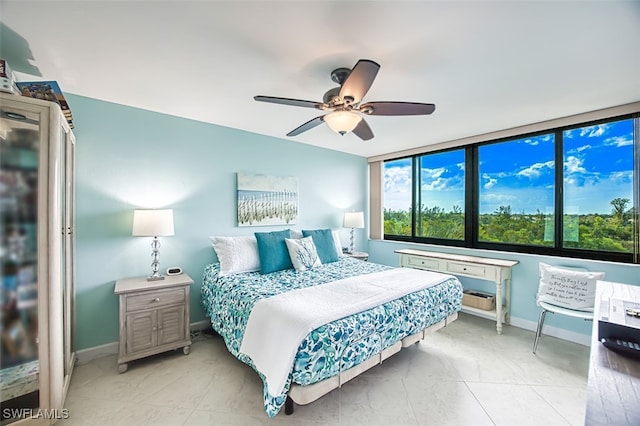 bedroom featuring a ceiling fan and baseboards