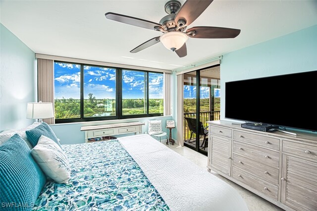 bedroom with access to exterior and a ceiling fan