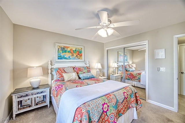 carpeted bedroom featuring ceiling fan, baseboards, and a closet