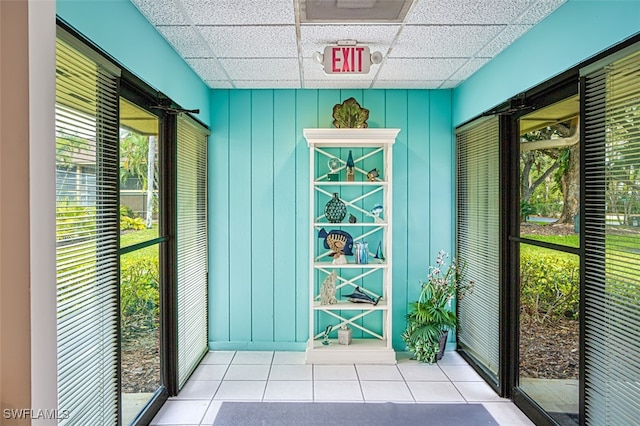 entryway featuring a drop ceiling and tile patterned floors