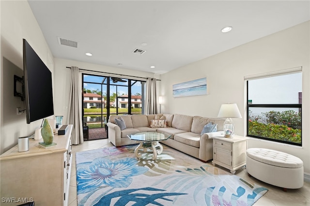 living room featuring light tile patterned flooring, visible vents, and recessed lighting