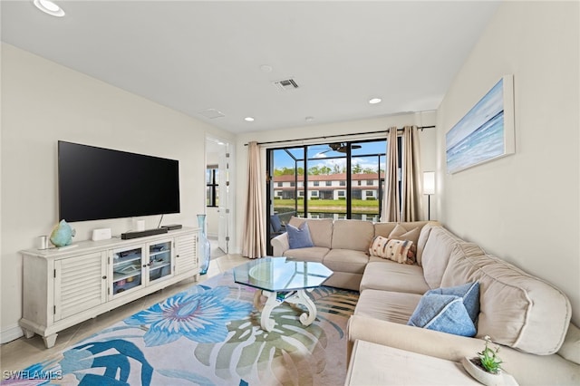 living area featuring recessed lighting, visible vents, baseboards, and light tile patterned floors