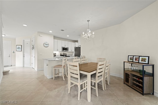 dining space featuring light tile patterned floors, recessed lighting, a notable chandelier, and baseboards