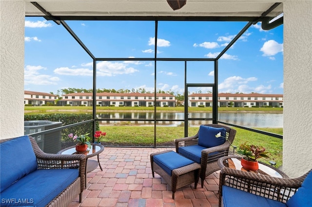 sunroom / solarium featuring a water view and plenty of natural light