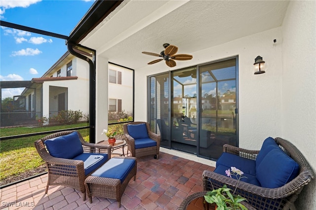 sunroom / solarium featuring ceiling fan and a wealth of natural light