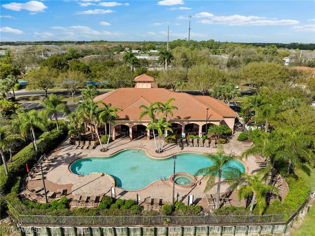 view of swimming pool with a patio and fence