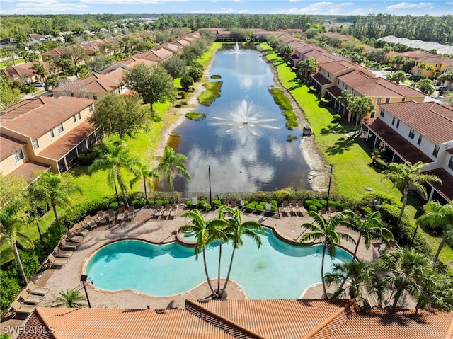 drone / aerial view featuring a residential view and a water view