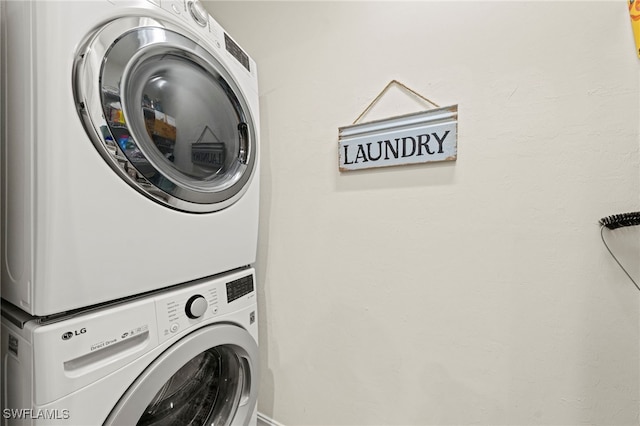 laundry area with stacked washing maching and dryer and laundry area