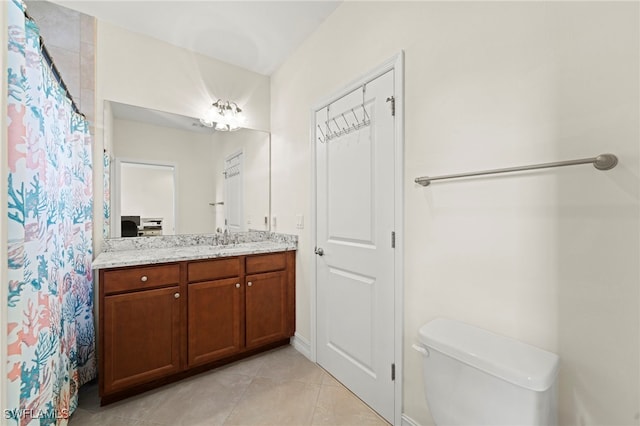 full bath featuring a shower with curtain, vanity, toilet, and tile patterned floors