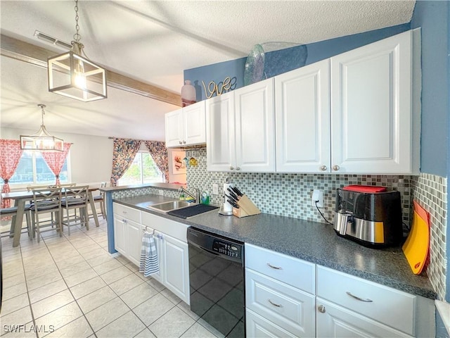 kitchen featuring dark countertops, black dishwasher, white cabinets, and a sink