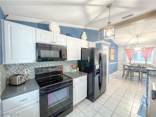 kitchen with lofted ceiling, white cabinets, visible vents, and black appliances