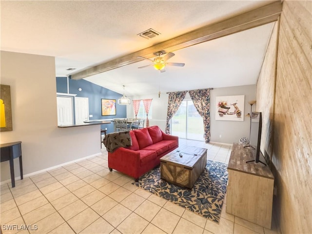 living room featuring vaulted ceiling with beams, light tile patterned floors, baseboards, and visible vents