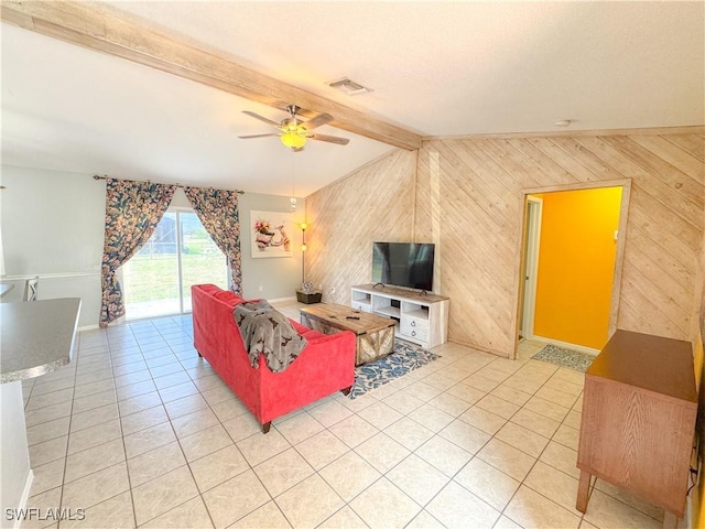 living area with visible vents, wood walls, and light tile patterned floors