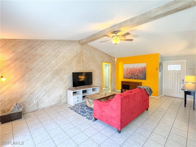 living room featuring light tile patterned flooring, wood walls, lofted ceiling with beams, and ceiling fan