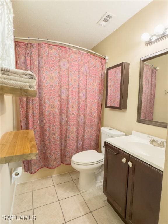 full bathroom featuring visible vents, a shower with shower curtain, toilet, vanity, and tile patterned flooring