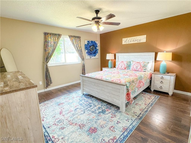 bedroom with ceiling fan, a textured ceiling, baseboards, and wood finished floors