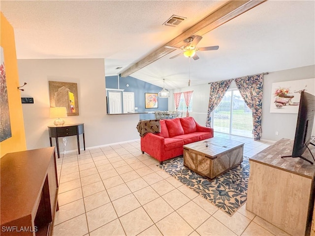 living area with light tile patterned floors, visible vents, lofted ceiling with beams, ceiling fan, and a textured ceiling