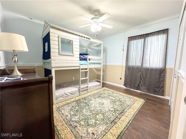 bedroom featuring ceiling fan, a textured ceiling, and wood finished floors