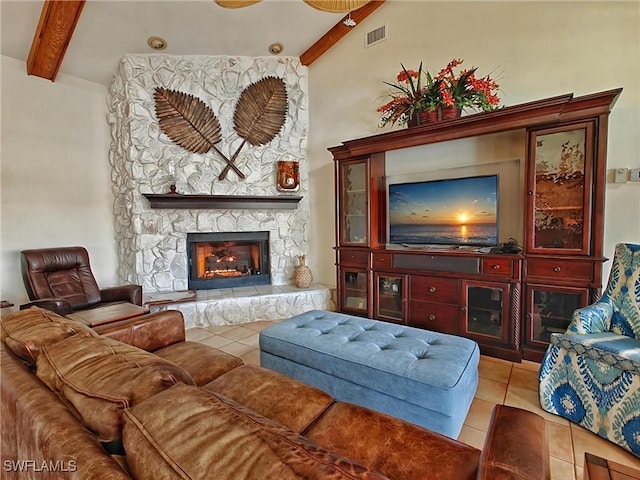 living room with beam ceiling, a fireplace, tile patterned flooring, and visible vents