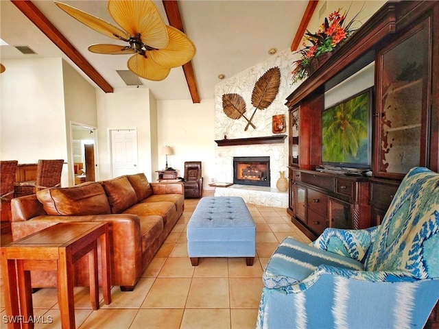 living area featuring a fireplace, visible vents, light tile patterned flooring, ceiling fan, and beamed ceiling