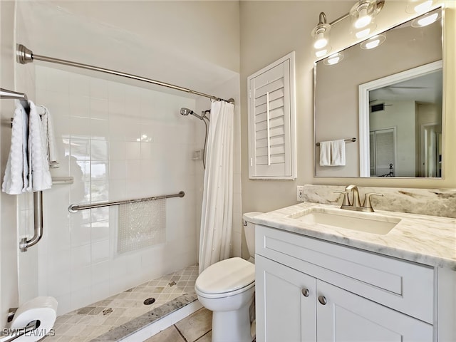 bathroom with vanity, a shower stall, and toilet