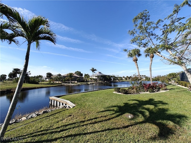 exterior space with a water view and a lawn