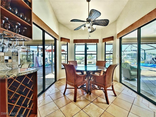 sunroom / solarium featuring ceiling fan