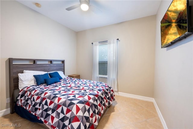 bedroom with tile patterned flooring, a ceiling fan, and baseboards