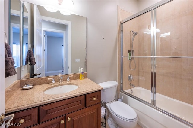 full bath with toilet, combined bath / shower with glass door, and vanity