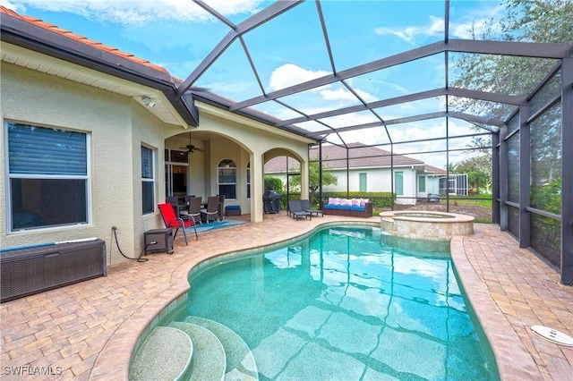 view of pool featuring a pool with connected hot tub, a patio, a lanai, and ceiling fan