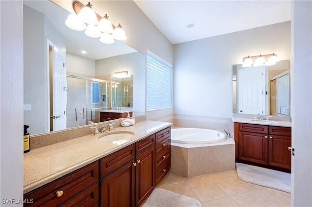 bathroom featuring a stall shower, tile patterned flooring, a sink, and a bath