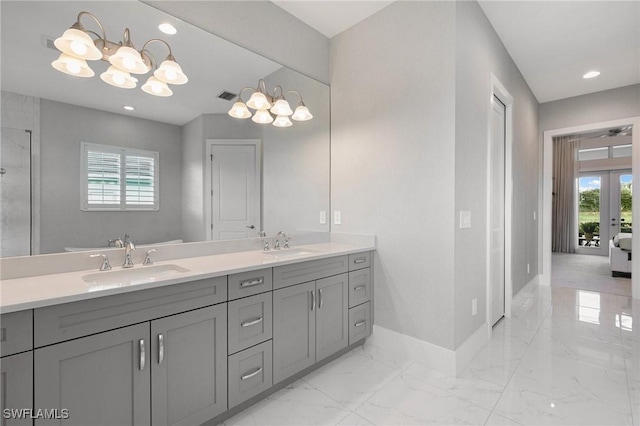 full bathroom with marble finish floor, baseboards, a sink, and french doors