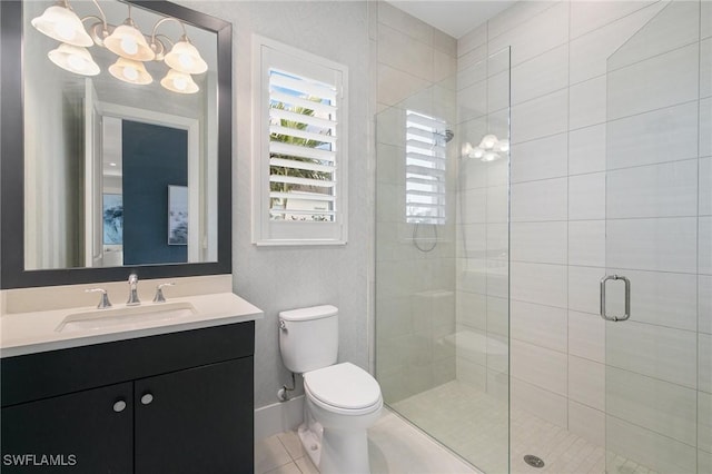 bathroom featuring baseboards, toilet, tile patterned flooring, vanity, and a shower stall